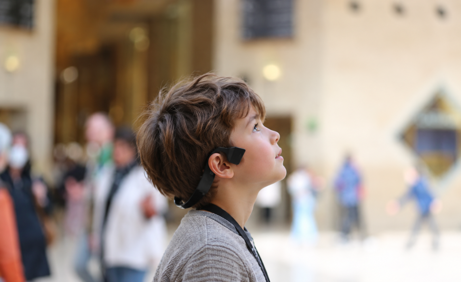 Un enfant découvre un lieu culturel avec un audioguide mains libres