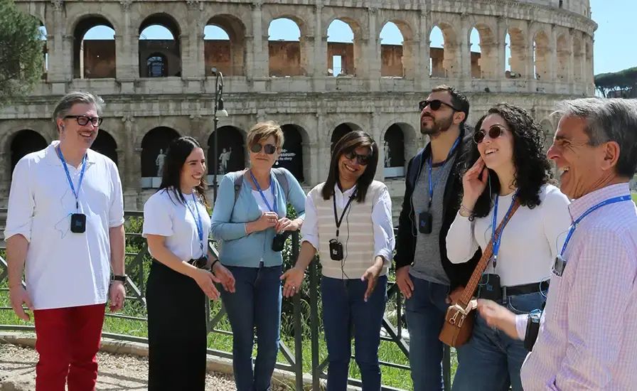 Visitors using multilingual audioguides at a cultural landmark